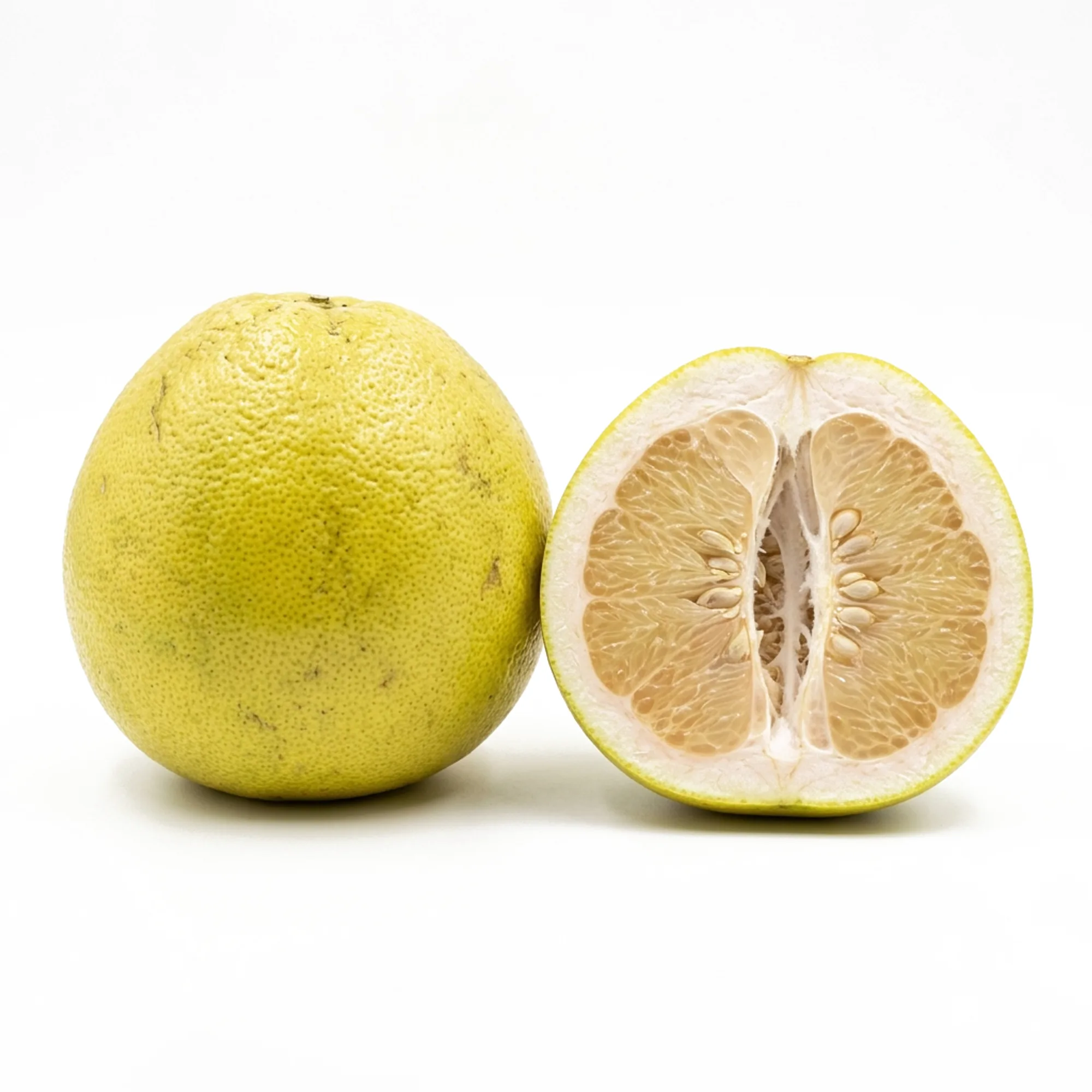Pomelo entier et coupé sur fond blanc